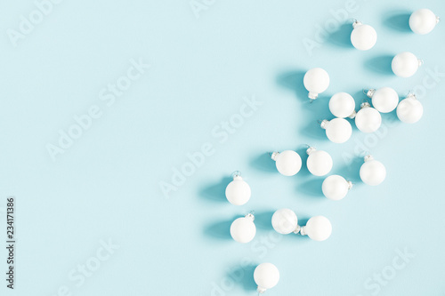 Christmas or winter composition. Pattern made of white balls on pastel blue background. Christmas, winter, new year concept. Flat lay, top view, copy space