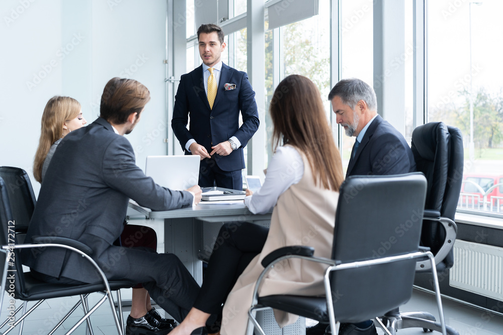 Businesspeople discussing together in conference room during meeting at office.