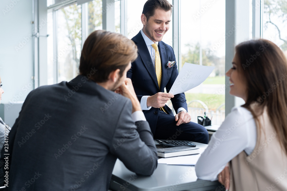 Businesspeople discussing together in conference room during meeting at office. Businesspeople discussing together in conference room during meeting at office.