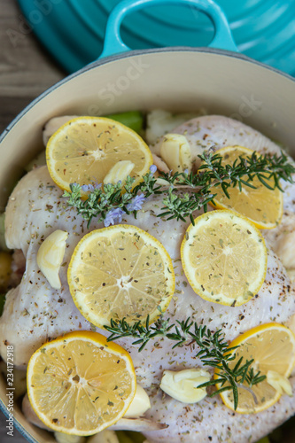 Whole Lemon and Rosemary Roasting Chicken in a Turquoise Cast Iron Pot