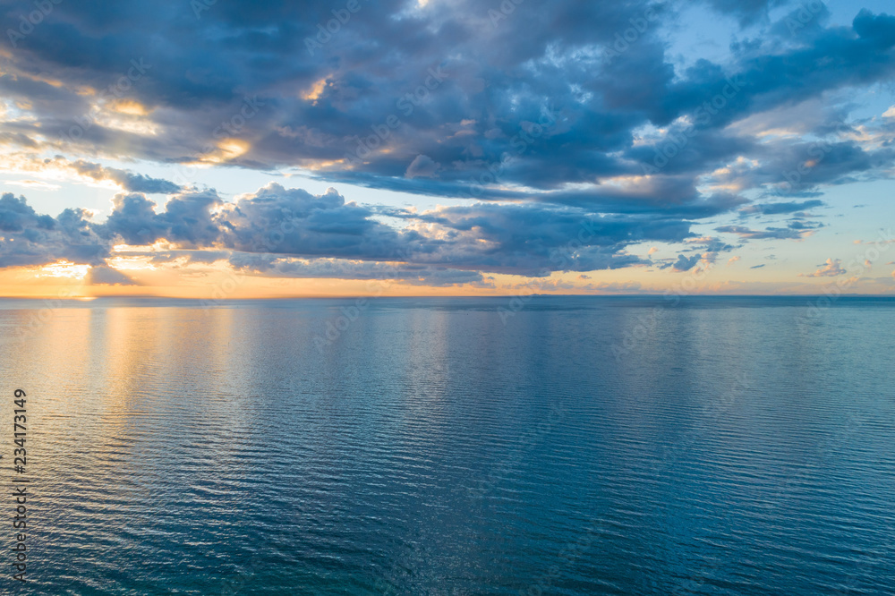 Noting but clouds over water at sunset - aerial view