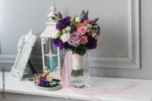 Boutonniere and a bridal bouquet on a  white background.
wedding background
Bouquet of the bride in a glass vase
