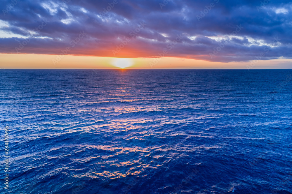 Obraz premium Nothing but sunset over water - aerial view