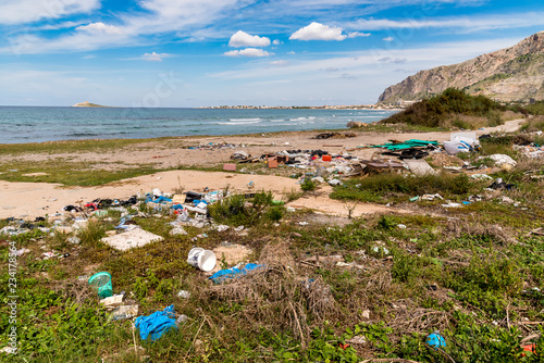 Fototapeta Naklejka Na Ścianę i Meble -  Coastal degradation with dirty beach, rubbish and domestic waste polluting the Capaci beach in province of Palermo, Sicily