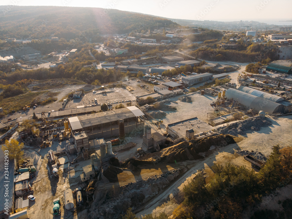 Aerial view from drone of industrial area with warehouses, buildings, trucks, industry equipment, heavy transport, production of building materials Aerial view from drone of industrial area with warehouses, buildings, trucks, industry equipment, heavy transport, production of building materials