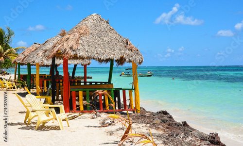 Obraz na płótnie Chairs under umbrella in the caribean sea