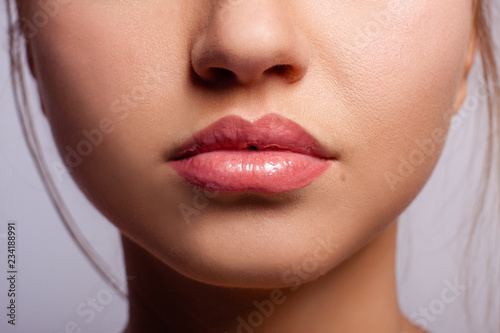 Beautiful lips of the young girl  with the lipstick applied on them