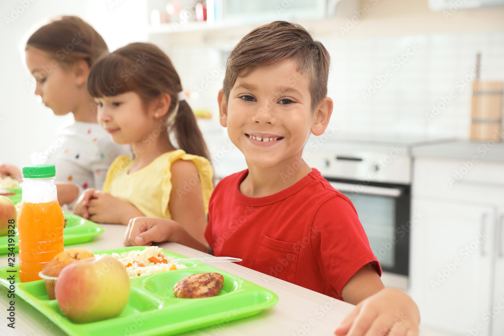 Children sitting at table and eating healthy food during break at school Children sitting at table and eating healthy food during break at school