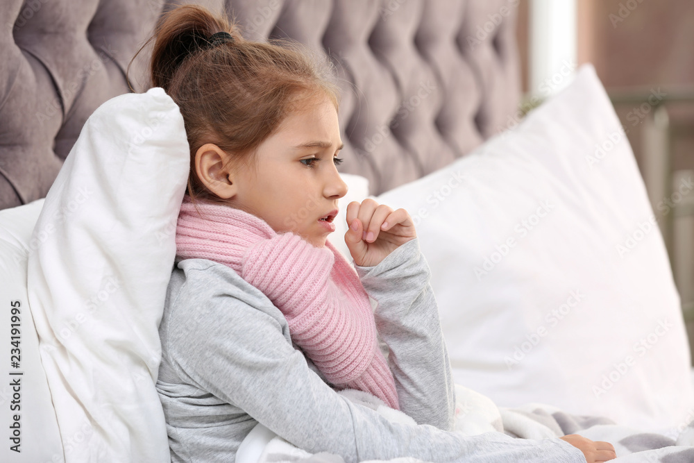 Little girl suffering from cough and cold in bed at home Little girl suffering from cough and cold in bed at home