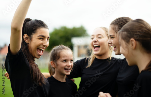 Cheerful female football players celebrating their victory