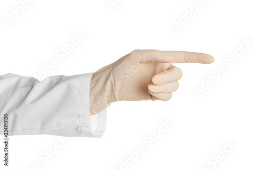 Doctor in medical glove pointing on white background