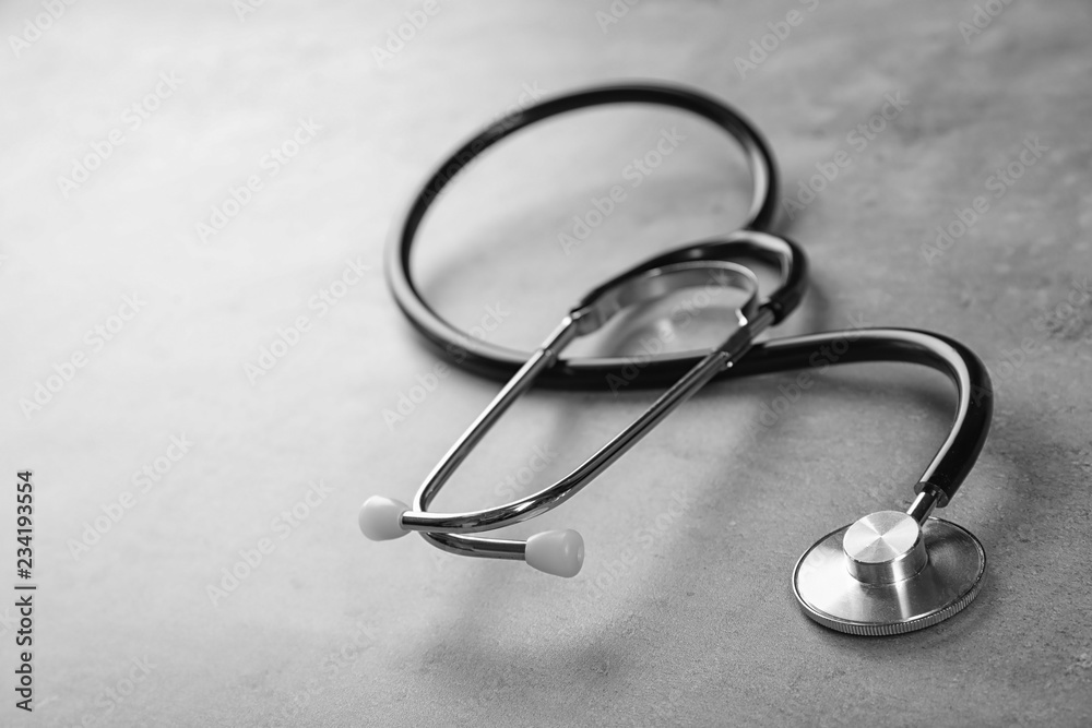 Stethoscope for checking pulse and space for text on gray background Stethoscope for checking pulse and space for text on gray background