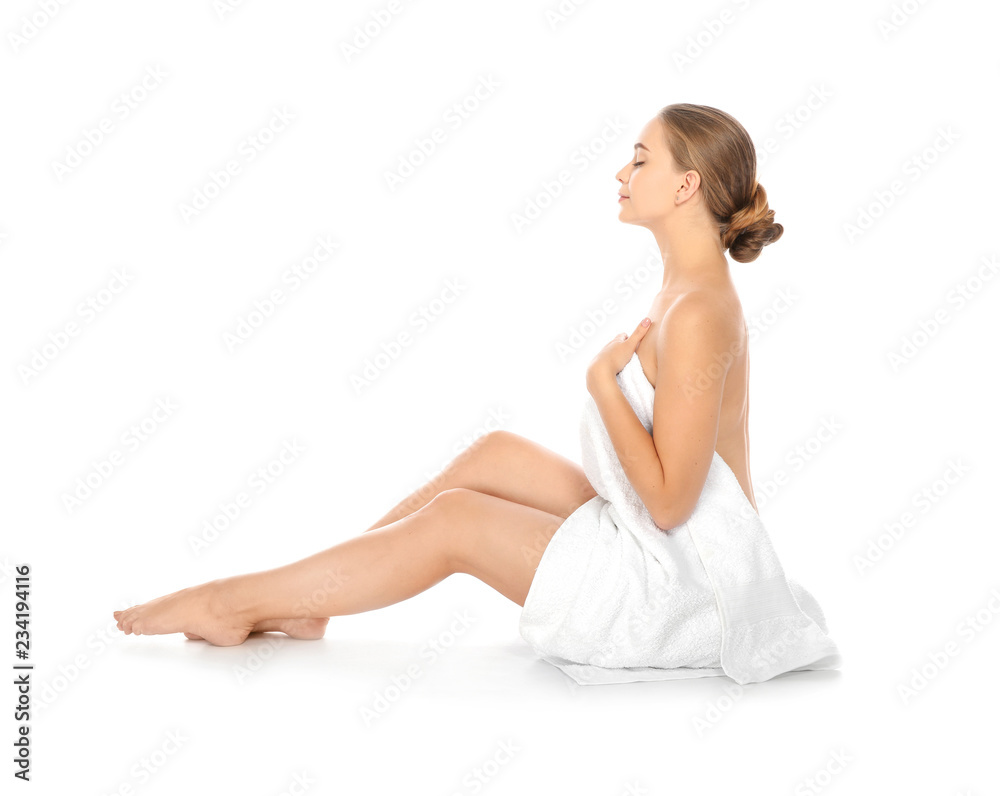 Portrait of young pretty woman with towel sitting on white background