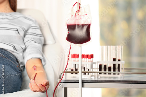 Tablou canvas Woman making blood donation at hospital, closeup