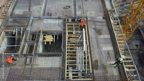 ISTANBUL - TURKEY 10 JULY 2017 -Aerial view of construction workers work on top of the building at construction site 2
