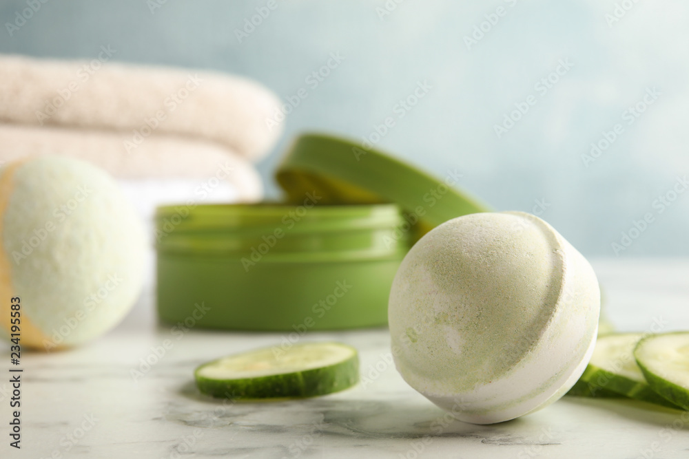Bath bomb and cucumber slices on marble table. Space for text Bath bomb and cucumber slices on marble table. Space for text