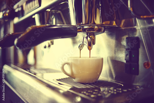 Professional coffee machine making espresso in a cafe photo