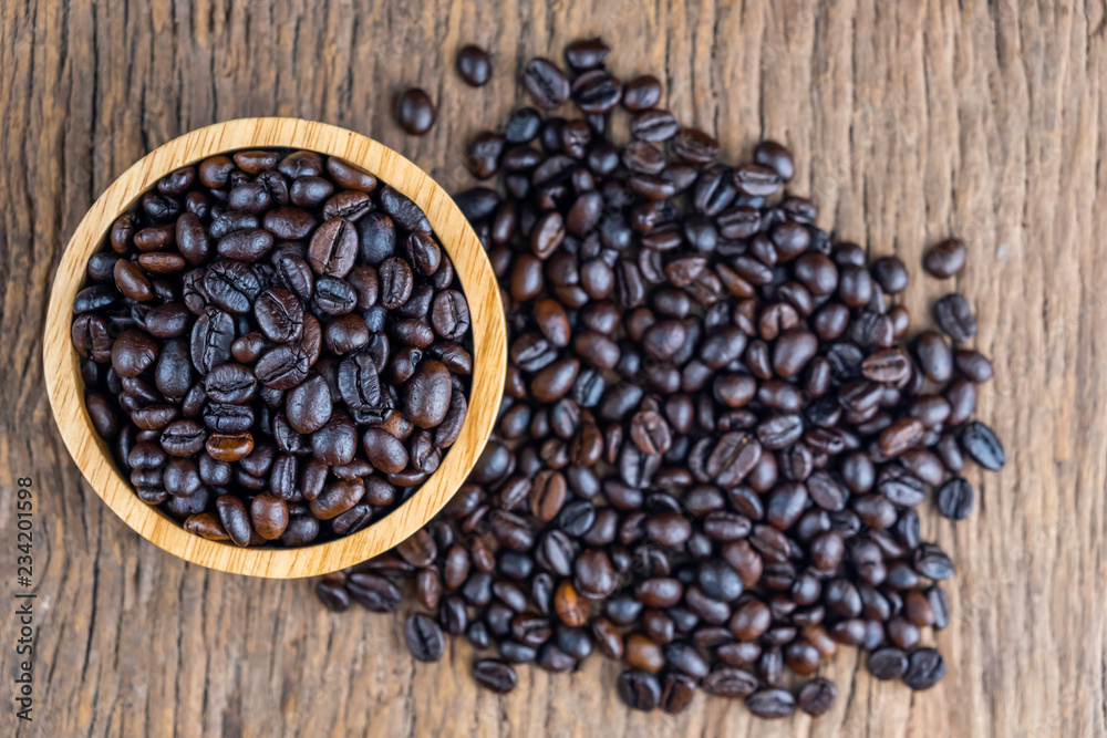 Fototapeta premium coffee beans on wooden bowl isolated top viwe on old wood background.