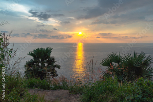 panorama sunset at Laem Promthep Cape. The landmark and popular viewpoint of Phuket Thailand. in every day a lot of tourists come here to watching sunset..