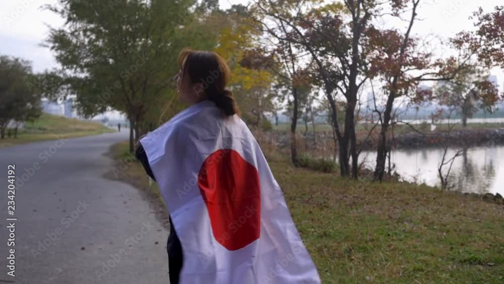 Japanese woman running happily with her countries flag, HD slow motion. Japanese woman running happily with her countries flag, HD slow motion.