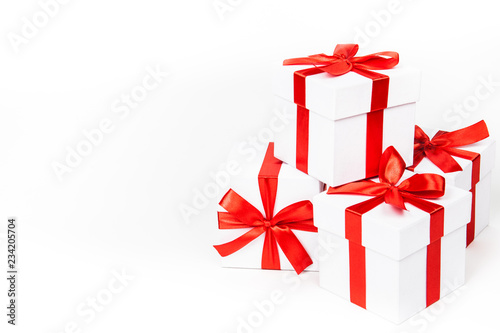 White boxes with a red satin ribbon bow Isolated on white background, Isolated