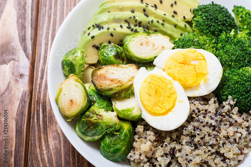 Buddha bowl with quinoa , eggs , avocado , brussels sprouts and broccoli
