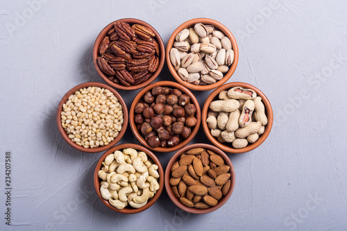 Mix of nuts : Pistachios, almonds , walnuts , pine nut , hazelnuts and cashew . Snack in bowl backgrond