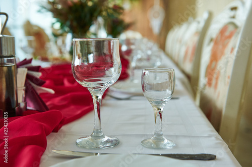 Close up picture of empty wine glasses in restaurant. © evafesenuk