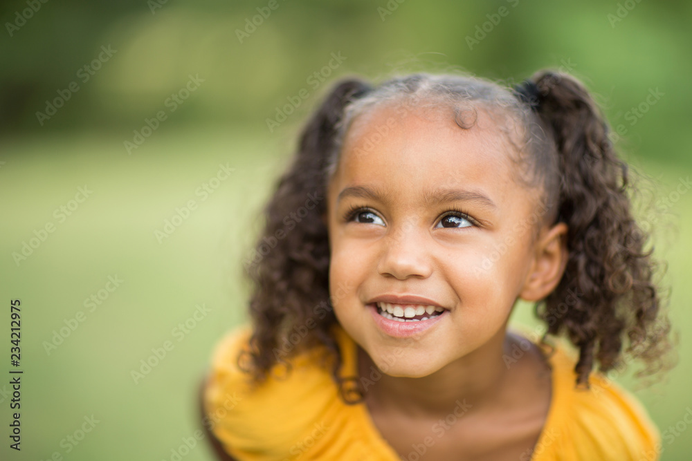 Cute mixed race little girl laughing and smiling. Cute mixed race little girl laughing and smiling.