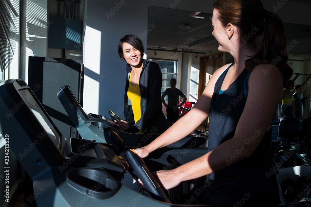 Friends working out together in gym Friends working out together in gym