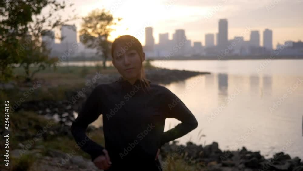 Beautiful fit Japanese woman ready for early morning run, HD, slow motion. Beautiful fit Japanese woman ready for early morning run, HD, slow motion.