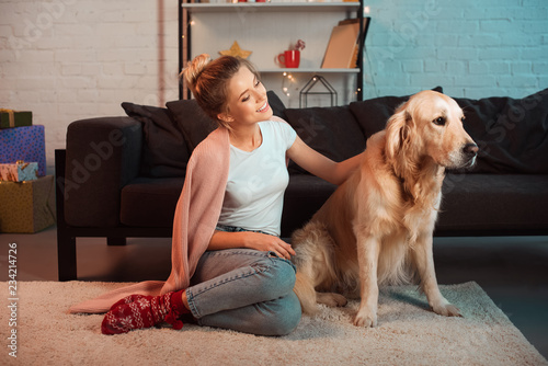 Wallpaper Mural beautiful young blonde woman sitting on floor and stroking golden retriever dog at christmas time Torontodigital.ca