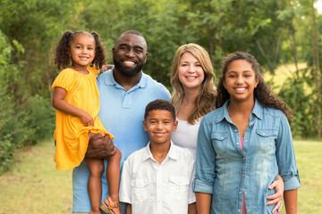 Portrait of a multi ethnic family laughing.