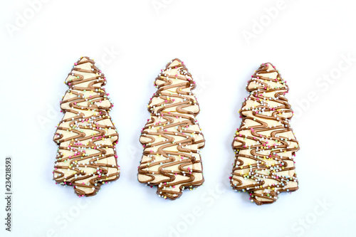 Christmas biscuites dessert in tree shape, decorate with chocolate and sugur on isolate white background, christmas cookies for party. top view photo