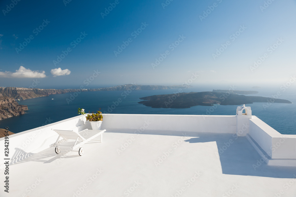 Chaise lounge on the terrace with sea view. Santorini island, Greece