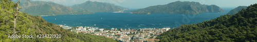 Nature landscape with a city by the shore of the sea between the hills. mountain town panorama © maxkolmeto