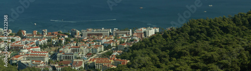 Fototapeta Naklejka Na Ścianę i Meble -  Nature landscape with a city by the shore of the sea between the hills. mountain town panorama