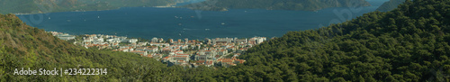 Nature landscape with a city by the shore of the sea between the hills. mountain town panorama © maxkolmeto