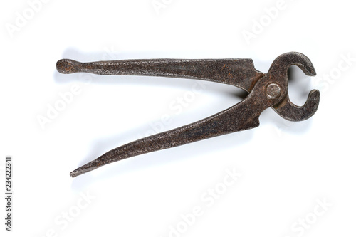 Vintage grungy forged pincers on white background. Vintage tools