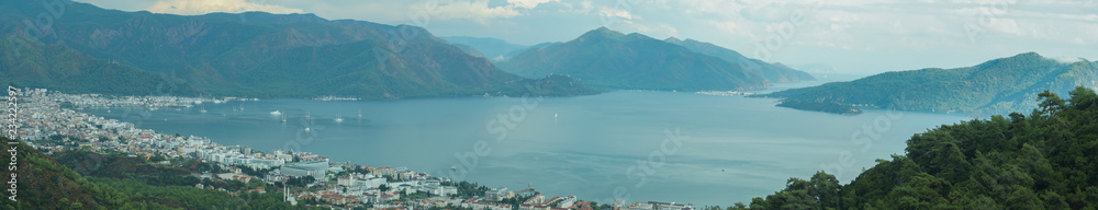 Nature landscape with a city by the shore of the sea between the hills. mountain town panorama