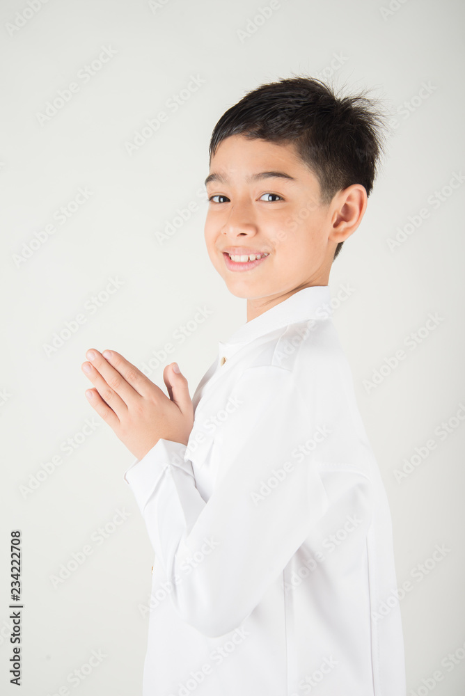 Little asian boy praying in Thai costume isolate on white background Little asian boy praying in Thai costume isolate on white background