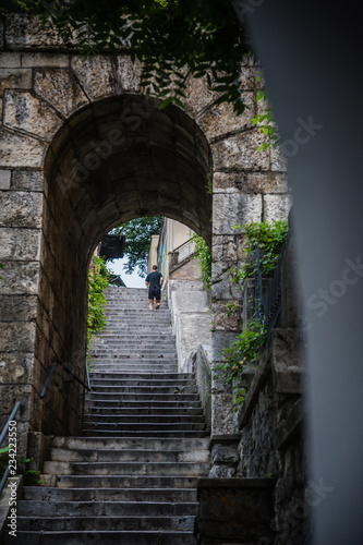 Running man in old city stone steps