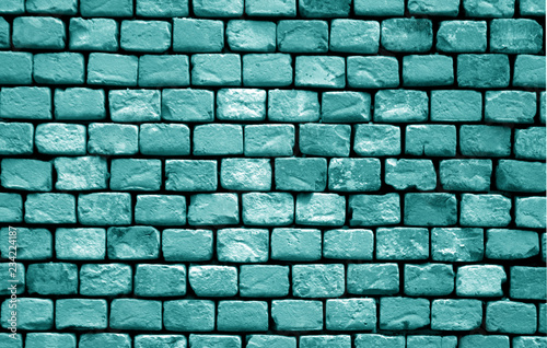 Old grungy brick wall surface in cyan tone.
