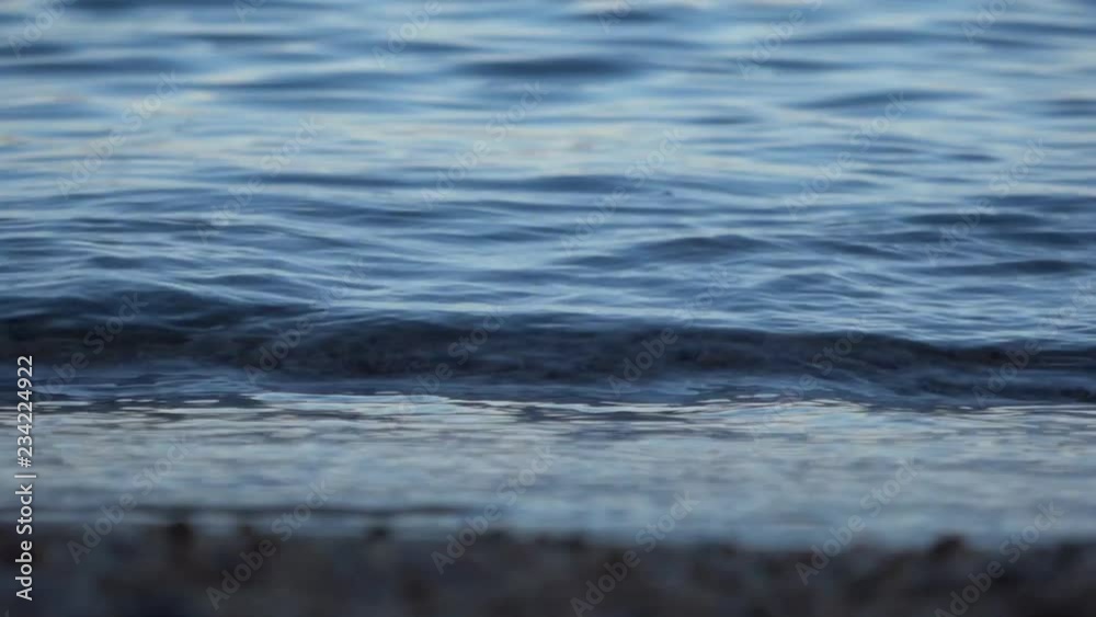 Slow motion waves on the beach at sunrise Slow motion waves on the beach at sunrise