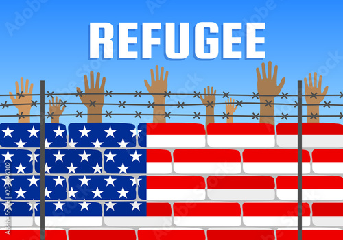 refugees raising hands behind american flag brick wall fence