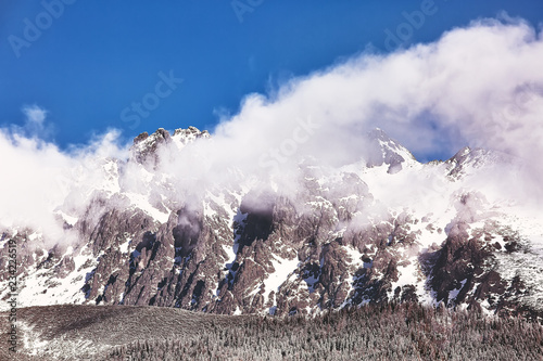 Mountains in snow covered with larch trees in Tatranska Lomnica, popular travel destination and ski resort in Slovakia