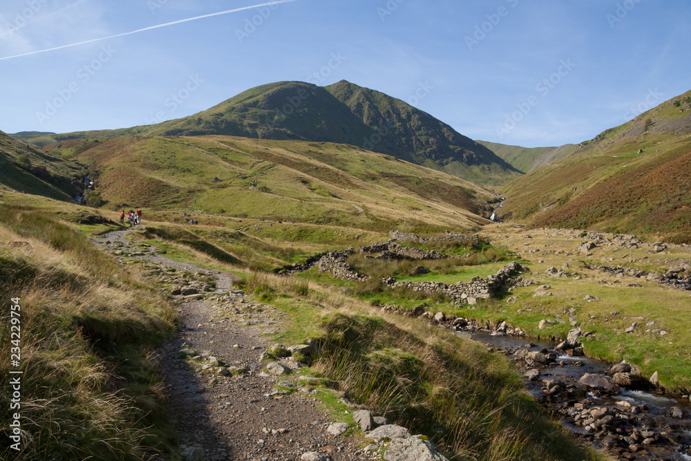 People walking up footpath to Helvellyn mountain near Glenridding, Lake District