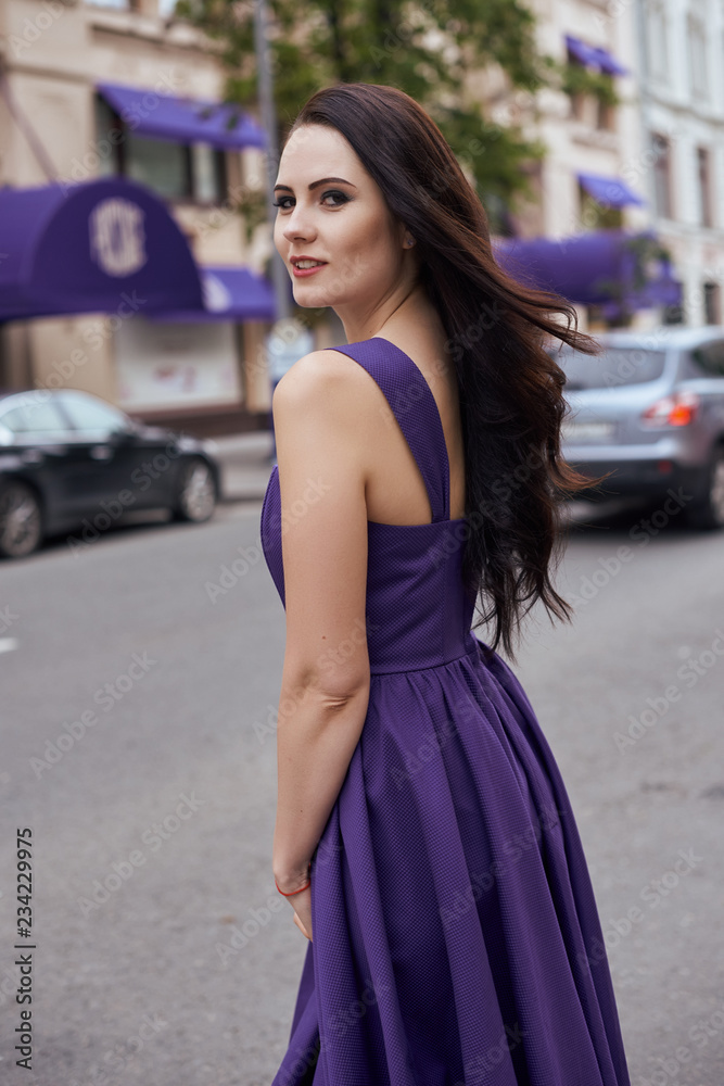 Street fashion concept: full body portrait of young beautiful woman walking in the city. Model looking aside. Toned and Filtered Photo. Street fashion concept: full body portrait of young beautiful woman walking in the city. Model looking aside. Toned and Filtered Photo.