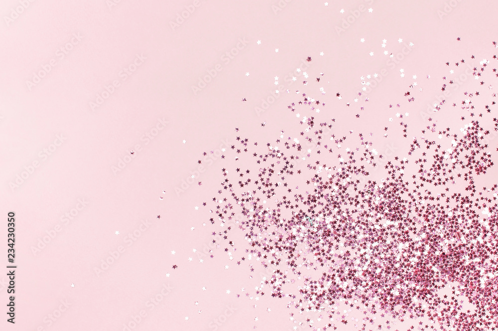 Pink holographic glitter confetti in the form of stars on pink background Flat lay top view copy space. Festive holiday pastel backdrop. Birthday, congratulations, Christmas, New Year Pink holographic glitter confetti in the form of stars on pink background Flat lay top view copy space. Festive holiday pastel backdrop. Birthday, congratulations, Christmas, New Year