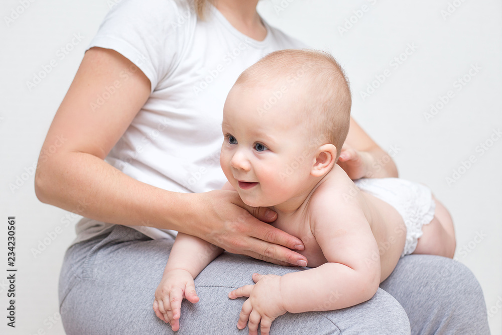 mother and her baby doing exercises on a ball mother and her baby doing exercises on a ball
